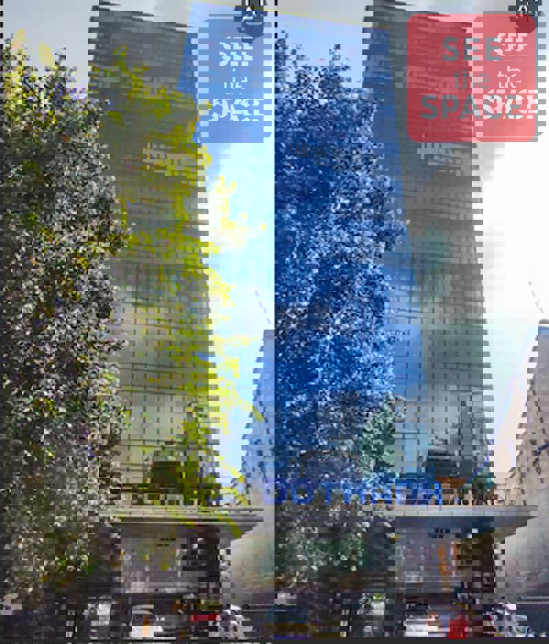 Exterior of Yersin Building District 1 featuring modern black reflective glass design.